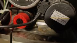 Close-up of heating system components with visible electrical and hydraulic elements.
