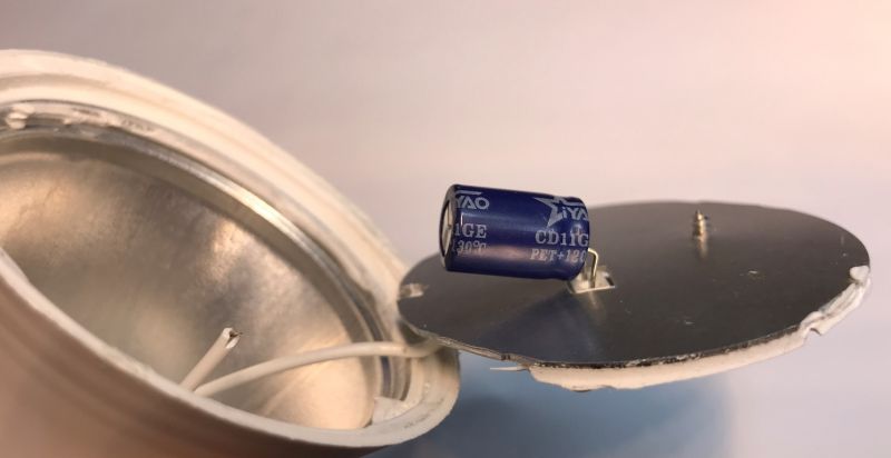Inside of a Bluetooth RGB/CCT Bulb Open part of a colorful Bluetooth RGB/CCT bulb showing a capacitor and internal electronics.
