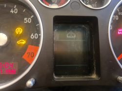 Close-up of car gauges and indicators, with one of the LEDs under the display not lit.