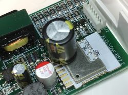 Close-up of a ceiling light electronic module with capacitors and CBU component.