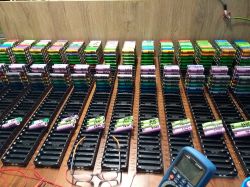 Organization of 18650 Cells for Energy Storage Stacks of 18650 cells arranged on a table, prepared for building an energy storage system.