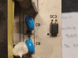 Electronic components on a circuit board, labeled as C9 and OC3.
