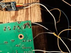 PCB with soldered wires and visible solder joints.