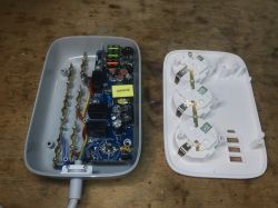Interior of LDNIO SEW3452 Power Strip Interior of a disassembled LDNIO SEW3452 power strip showing electronics and sockets.