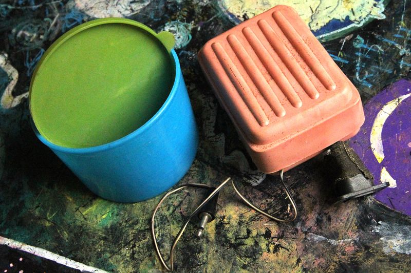 Plastic container and pink soap dish repurposed as electronic enclosures