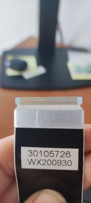 Close-up of a ribbon cable with a label containing numbers.