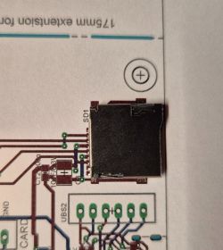 MicroSD slot mounted on a printed circuit board layout.