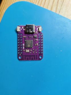 Purple printed circuit board with USB-C port and chip on a blue background.