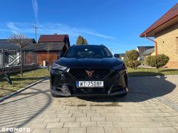 Black Cupra SUV seen from the front on a driveway in front of a house