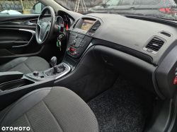 Interior of an Opel Insignia showing the dashboard, steering wheel, and manual gear shift.