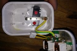 Interior of an Electrical Device with Visible Wires Interior of a plastic casing with electrical components and wires with yellow-green insulation.