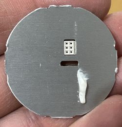 Close-up of the back of an LED board with a transparent glue mark.