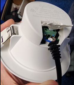 Close-up of a damaged electrical device with exposed wires.