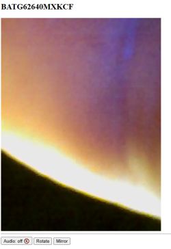 Blurry image with purple, yellow, and black areas, without clear details or recognizable objects.