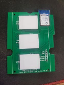 Circuit Board with Electronic Module Green circuit board with three buttons and an electronic module.