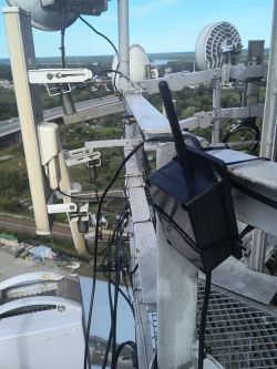 View of antennas and radio equipment mounted on a high industrial mast
