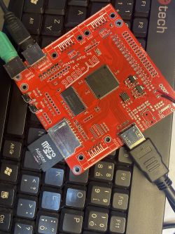 A printed circuit board with various connectors and electronic components on a laptop keyboard.