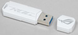Biały pendrive ASUS ROG z odłączoną nasadką, widok z boku na szarym tle