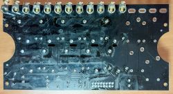 Touch light switch circuit board with visible soldered components and screw terminals.