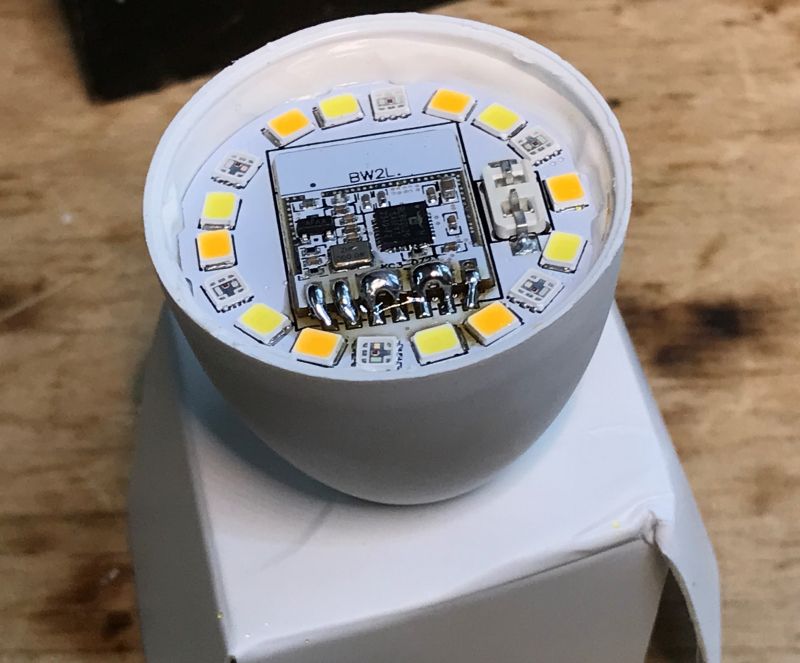 LED Circuit Board with Electronic Components Round circuit board with LEDs and electronic components on a white surface.