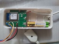 Open water leak sensor showing electronics and battery.
