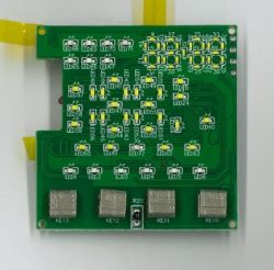 Green PCB with many SMD parts and silkscreen labels LED and KEY