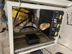 Energy storage enclosure under construction with visible components and batteries.
