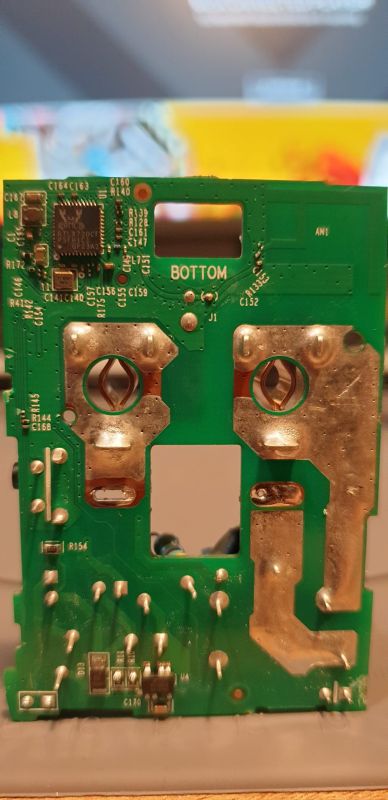 Bottom side of a green PCB labeled “BOTTOM,” with an IC and large soldered contact areas