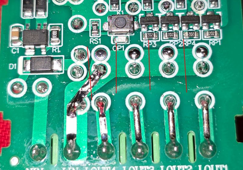 Close-up of a circuit board with electronic components and soldering points.