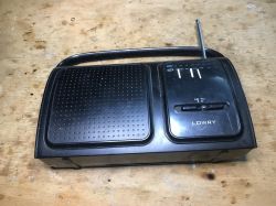 LOWRY Portable Radio with Antenna Black LOWRY portable radio with an extended antenna on a wooden surface.