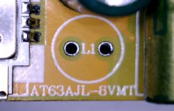 Close-up of a yellow printed circuit board labeled AT63AJL-8VMT.