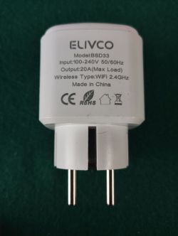 White ELIVCO plug adapter with printed specs and two prongs on a dark background