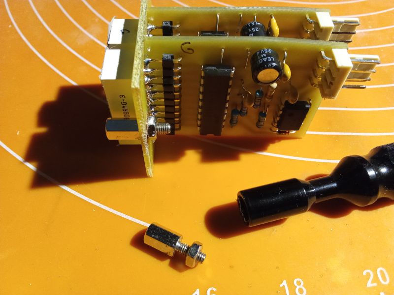 Circuit board with electronic components on an orange background.