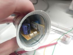 Inside of a light bulb showing a PCB and electronic components.