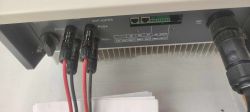 View of inverter connectors with PV cables and communication ports connected.