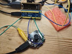 Joystick module connected to development board with wires on wooden desk