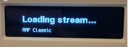 Display showing Loading stream... message and station name RMF Classic.